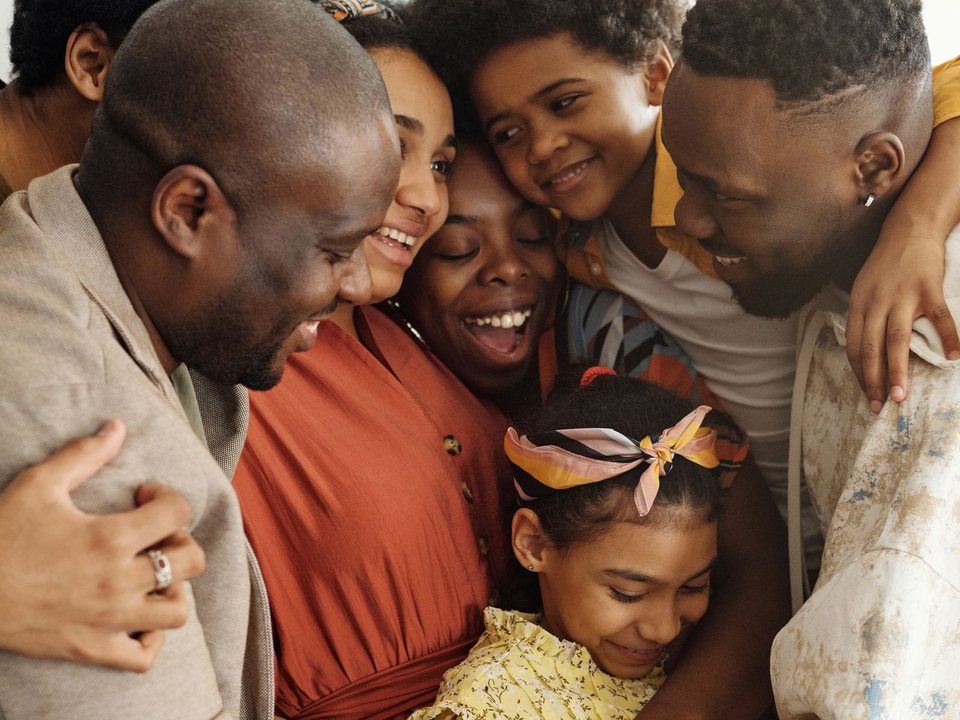 A family sharing a big group hug